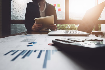 Economic research , Business woman analyzing income charts and graphs to plan marketing concept...