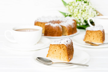 Bundt cake with sugar frosting. Spring breakfast set. Morning tea with flowers. Selected focus