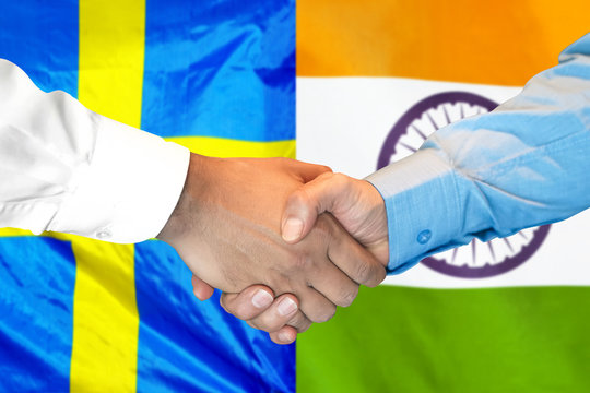 Business handshake on the background of two flags. Men handshake on the background of the India and Sweden flag. Support concept
