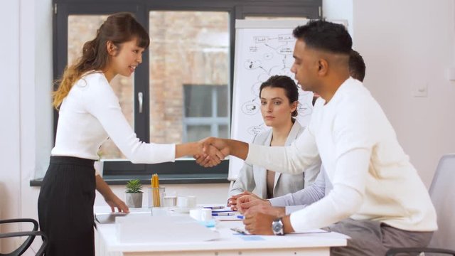 job, hiring and employment concept - international team of recruiters having interview with asian female employee at office