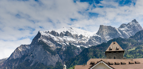 skyline of Maienfeld with snowcapped mountain peaks behind