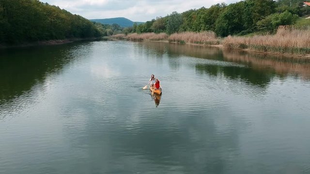 Couple paddling boat on a lake