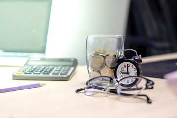 Selective focus time with coin money.concept saving money for finance accounting
