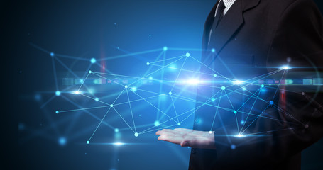 Handsome person holding hologram screen displaying modern cloud based web system technology
