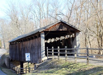 A view of the old wood covered bridge in the park.