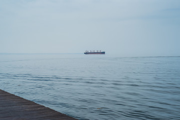 Cargo ship at sea horizon