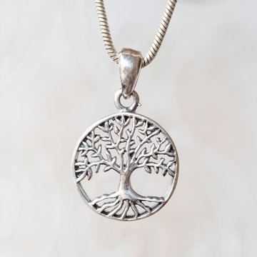 Silver tree in madala pendant on natural white background