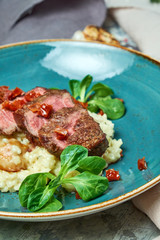 White rice with beef. Rizzotto. Gray light textured background. Beautiful serving of dishes