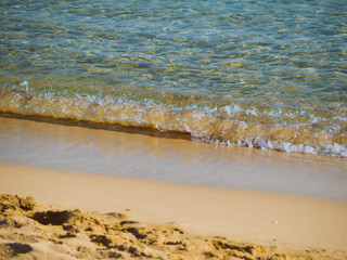 Small waves on a nice empty sandy beach - crystal clear water