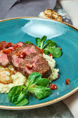 White rice with beef. Rizzotto. Gray light textured background. Beautiful serving of dishes