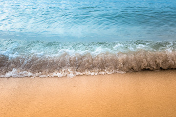Fototapeta na wymiar Soft wave of blue ocean on sandy beach.