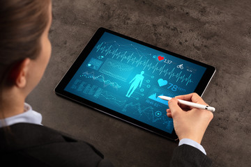 Business woman making healthy analysis on tablet
