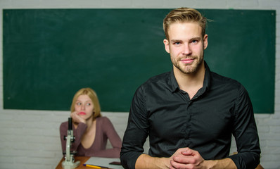 Youth mentoring. Man well groomed attractive teacher in front of classroom. Obsessed with...