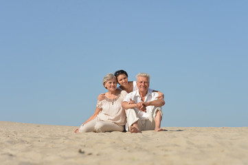 Portrait of people sitting on the sand