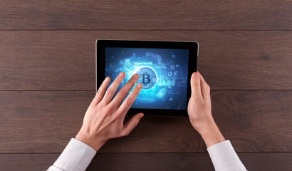 Hand working on tablet with cryptocurrency and network concept

