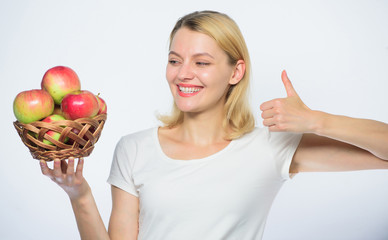 helpful and tasty. vitamin and dieting food. orchard, gardener girl with apple basket. Happy woman eating apple. farming concept. healthy teeth. autumn harvest. Spring seasonal fruit. thumb up