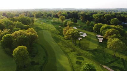 Sunrises over Lancaster countryside and golf course, aerial pan over breathtaking club
