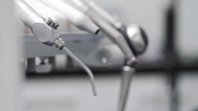 Part of dentist using dental drill during dental treatment