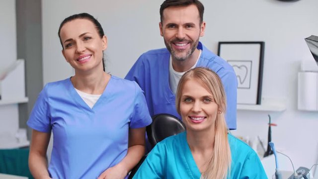 Portrait of three, smiling dentists in dentist's clinic