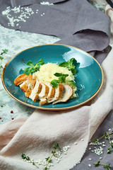 White rice with chicken breast. Rizotto. Gray light textured background. Beautiful serving of dishes. 