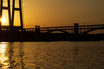Sunset over the river Dnieper. Bridge.