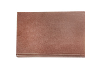 One brown color old blank book with hardcover isolated on white background. Top view