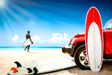 Red summer car and surfer on beach. Free space for your decoration and summer sunny day. 