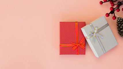 Two gift boxes, Christmas gift concept. 16:9 Gift boxes with ribbons on pink background. Copy space. Web banner format.