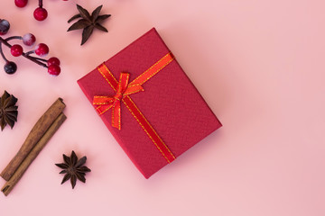 Red gift box on pink background. Christmas gift concept. Top view.