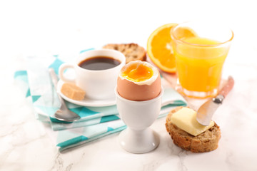 full breakfast with coffee cup, orange juice, bread and egg