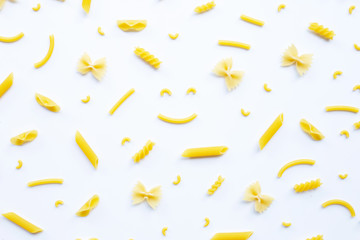 Fototapeta premium Different types of dry pasta on white.