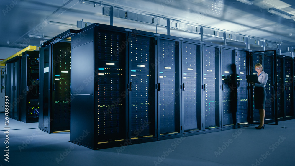 Aufkleber In Data Center: Female IT Technician Stands before Open Server Rack Cabinet, Uses Laptop Computer to Run Maintenance Diagnostics so that Mainframe Works at Optimal Functioning Level. 
