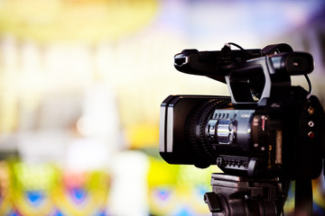 Video journalist capturing moving picture by camcorder in a event