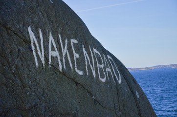 Word written on a mountain in the Swedish archipelago, Translation: Skinny dipping