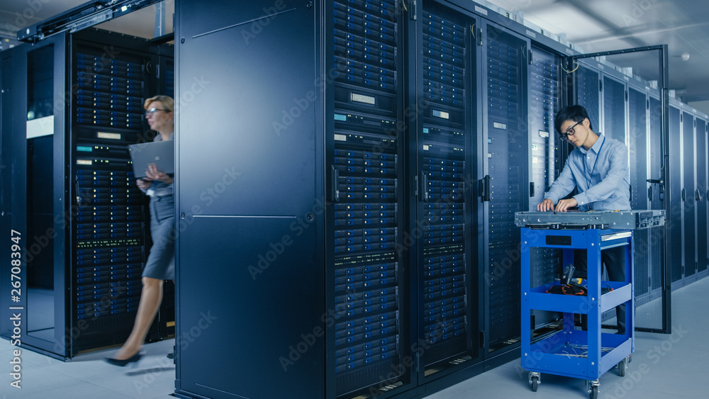 Aufkleber In the Modern Data Center: Team of IT Technicians Working with Server Racks, Man with Pushcart Changes Faulty Hard Drives, Doing Hardware Maintenance and Diagnostics.