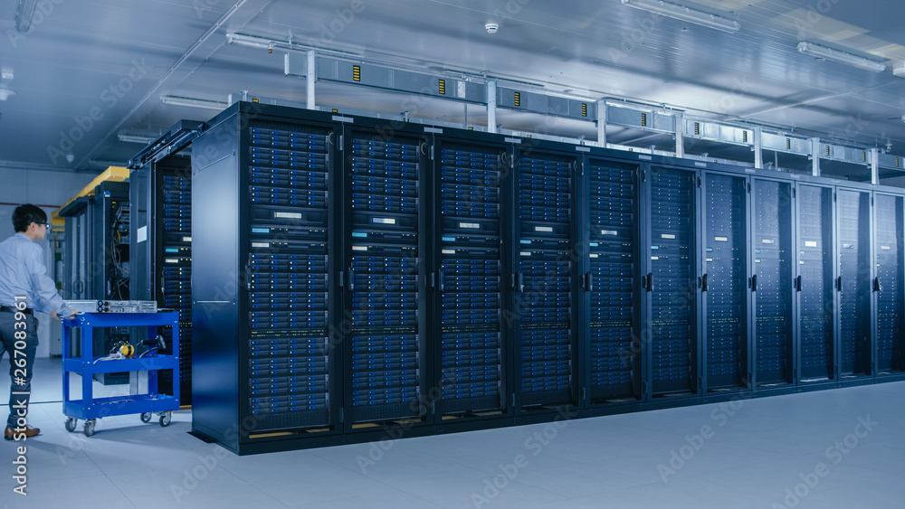 Poster In the Modern Data Center: Team of IT Technicians Working with Server Racks, Running Maintenance and Diagnostics, Checking Networking and Cloud Computing Optimal Functioning.