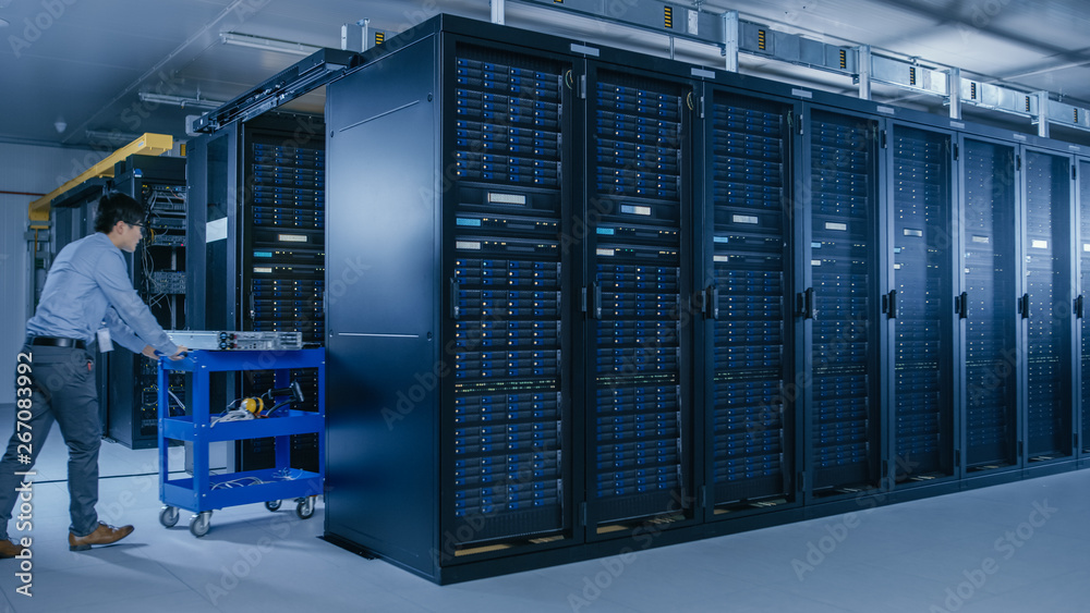 Leinwandbilder In the Modern Data Center: Team of IT Technicians Working with Server Racks, Running Maintenance and Diagnostics, Checking Networking and Cloud Computing Optimal Functioning.
