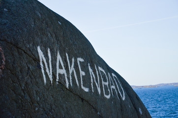 Word written on a mountain in the Swedish archipelago, Translation: Skinny dipping