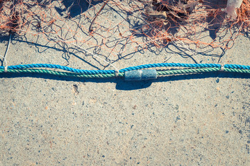 Fishnet with sinker on rope. Nautical marine background.