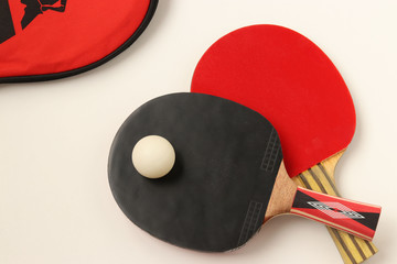 Red and black rackets for playing table tennis on a white background, top view, sport concept