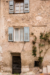 Fototapeta na wymiar Facade of the old European house. Facade of old houses and stone staircase in Italy. Medieval house and door.