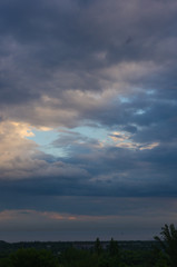 Landscape with dramatic light - beautiful golden sunset with saturated sky and clouds.