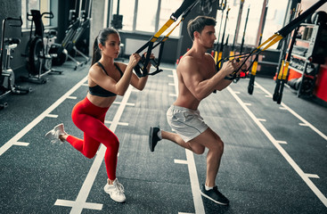 Fototapeta na wymiar Sporty couple in gym