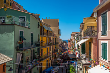 Fototapeta na wymiar Beautiful streets of Riomaggiore on a sunny day, Cinque Terre, Italia, Liguria