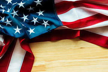 USA flag crumpled on wooden background