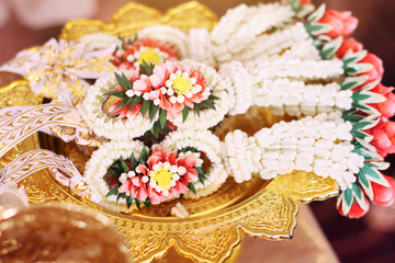 Flower garlands on a gold tray in tradition Thai wedding ceremony day. Jasmine garland