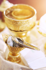 Golden conch set and flower garlands for Thai water pouring wedding ceremony