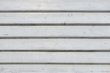 White vintage wooden boards in overlap cladding pattern