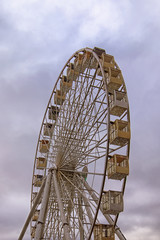 Close-up view of the Ferris wheel against stormy sky and gloomy clouds. Rainy weather in spring. Kyiv, Ukraine