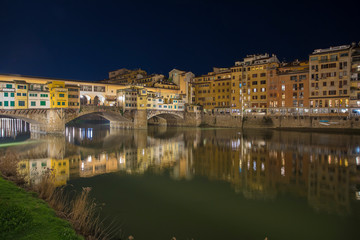 Fototapeta na wymiar Romantic Night view over the Arno River in Florence with Ponte Vecchio